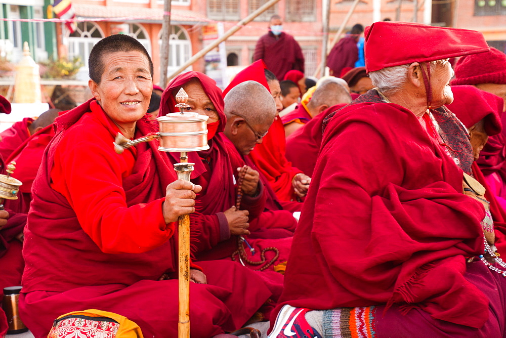 Tibetan Buddhist nun and prayer wheel, Boudhanath Stupa, Kathmandu, Nepal, Asia