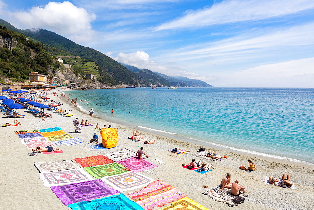 Blanket sellers showcasing their products on the beach at Monterosso, Cinque Terre, Liguria, Italy, Mediterranean, Europe