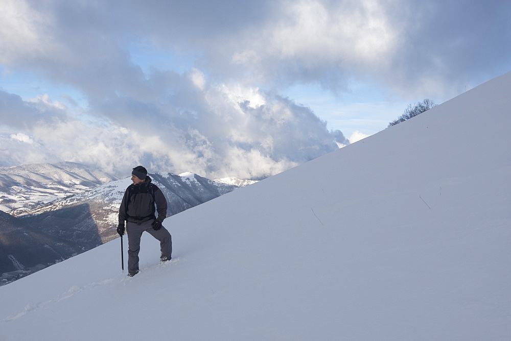 Hiker in winter, Motette, Umbria, Italy, Europe