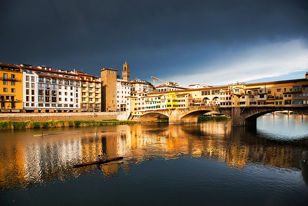 Ponte Vecchio reflected in the Arno River against a dark blue stormy sky, Florence, UNESCO World Heritage Site, Tuscany, Italy, Europe