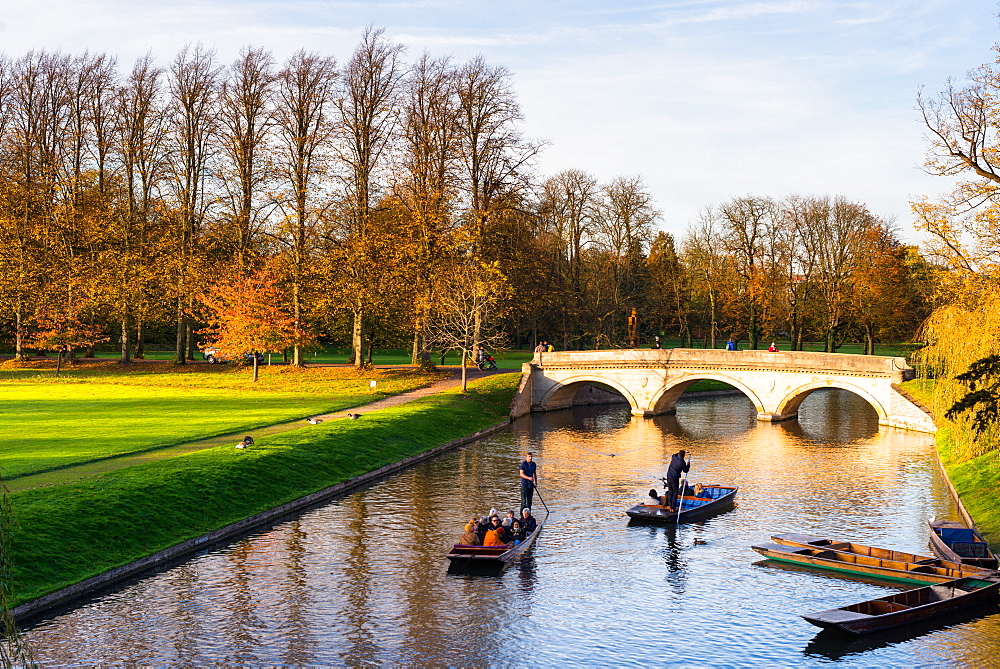 Punting on the Backs with the late evening light hitting Trinity College bridge, Cambridge, Cambridgeshire, England, United Kingdom, Europe