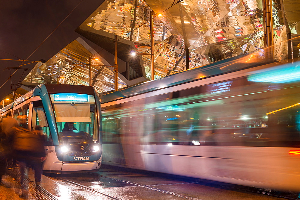 Night view of two trams at Glories station with the dazzling, reflective canopy to the rear, Barcelona, Catalonia, Spain, Europe