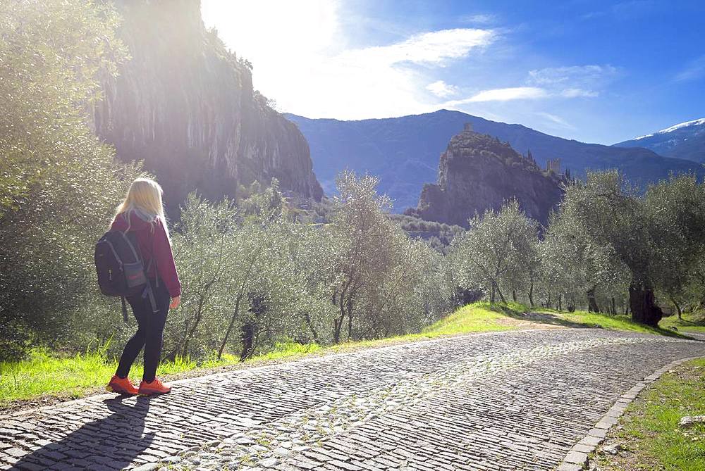 A young tourist walks on the Via Crucis, Arco di Trento, Trento province, Trentino-Alto Adige, Italy, Europe