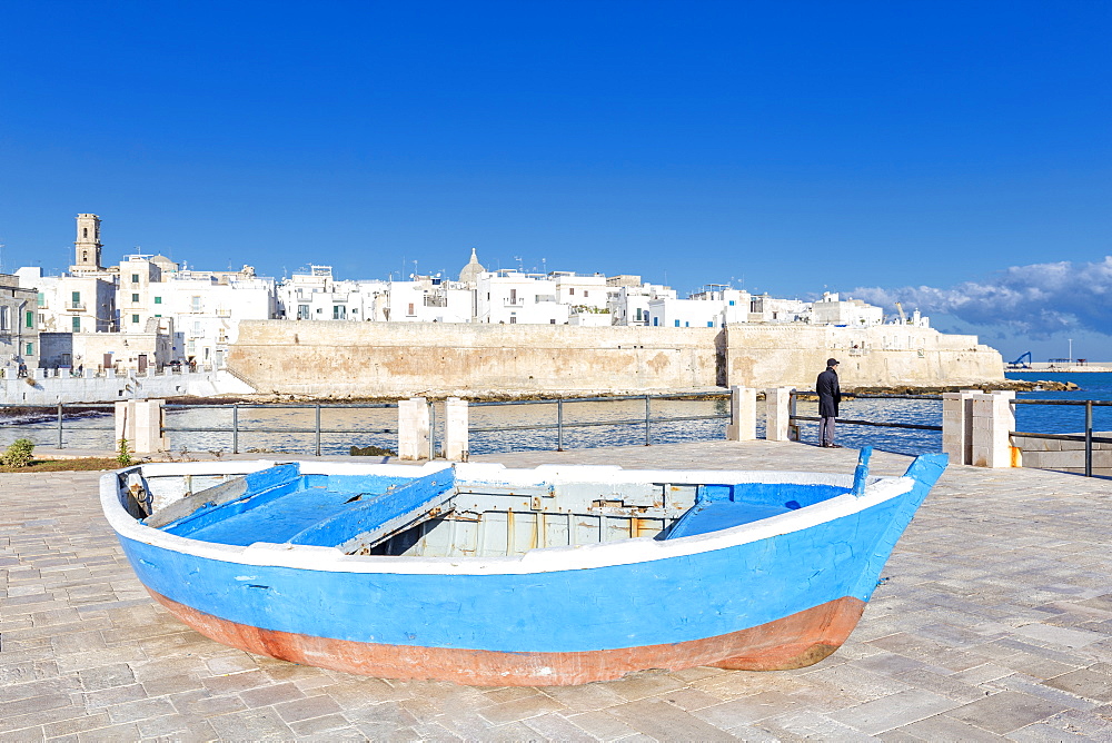 Old boat with the Italian old town in the background, Monopoli, Apulia, Italy, Europe