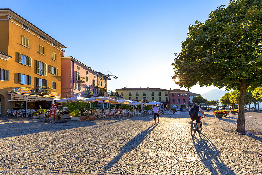 Colourful square of the village of Colico with passing tourists, Lake Como, Lombardy, Italian Lakes, Italy, Europe