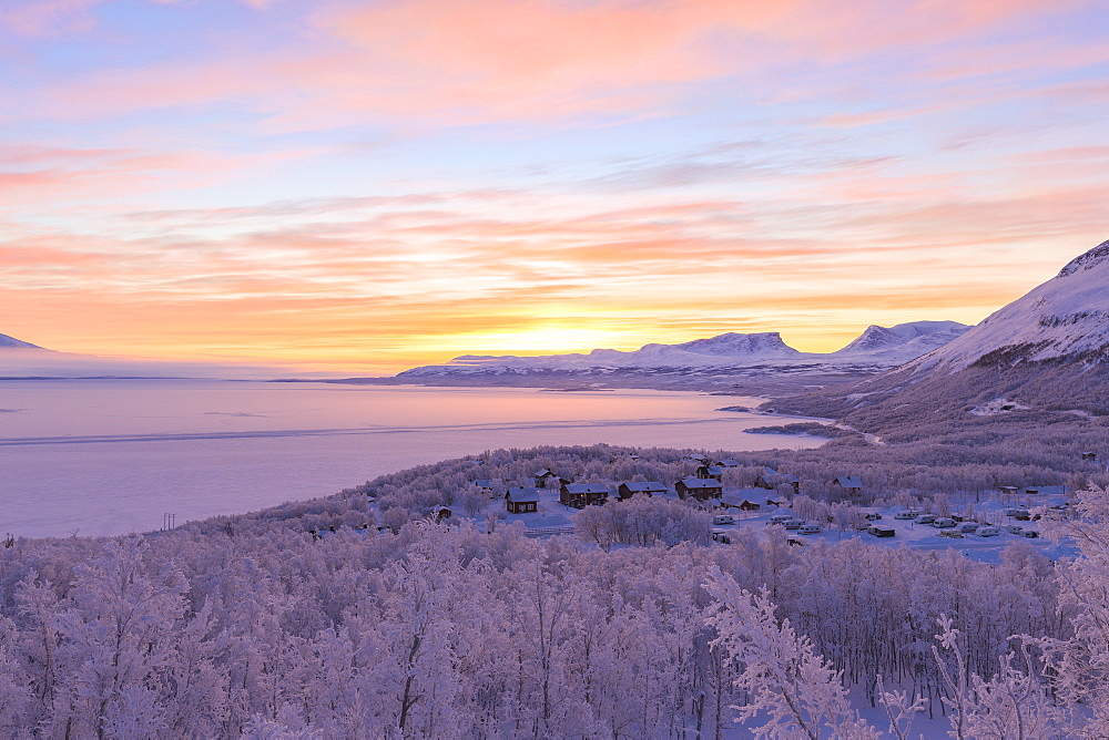 Sunrise illuminates Bjorkliden houses and camping. Bjorkliden, Norbottens Ian, Sweden, Scandinavia, Europe