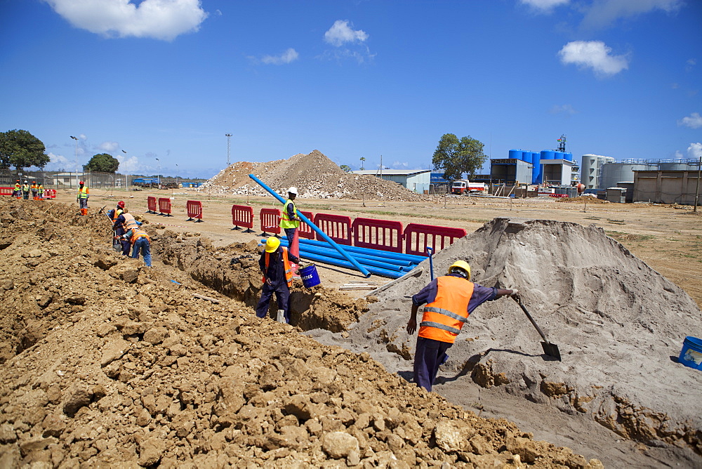 Workmen dig a trench and install a new pipeline, Mtwara, Tanzania, East Africa, Africa