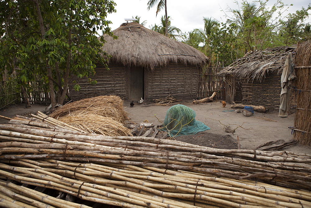 A traditional mud hut home with a thatched roof and a solar panel on the top of it, Tanzania, East Africa, Africa