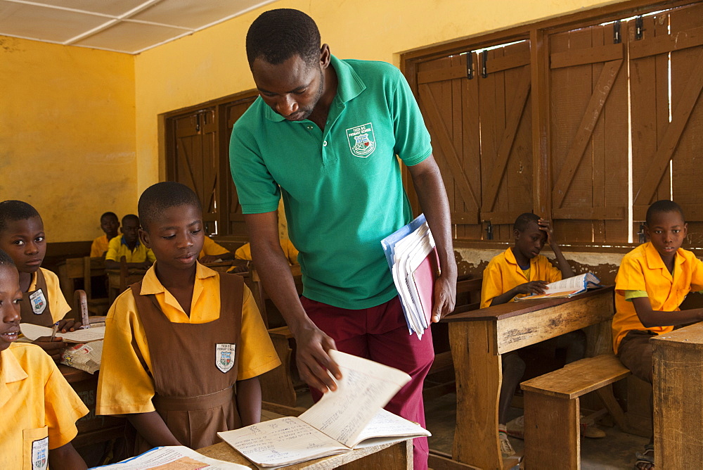 A male teacher teaching a classroom of children at a primary school in Ghana, West Africa, Africa