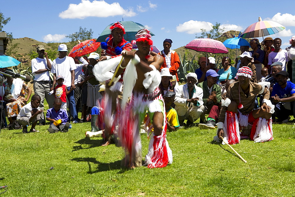 Traditional dancers entertain the crowds at one of Send a Cow's passing on ceremonies, Lesotho, Africa