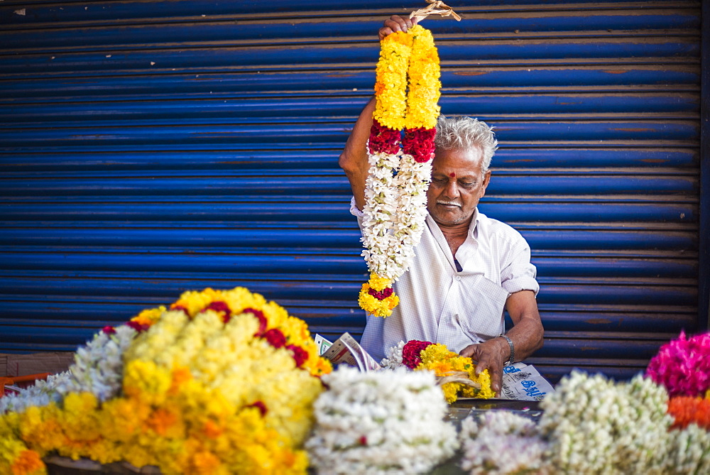 Selling flowers by a temple at at market in Munnar, Western Ghats Mountains, Kerala, India, Asia