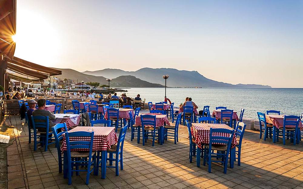 Restaurant at Paraliaki promenade at sunset in Kissamos, Crete, Greek Islands, Greece, Europe