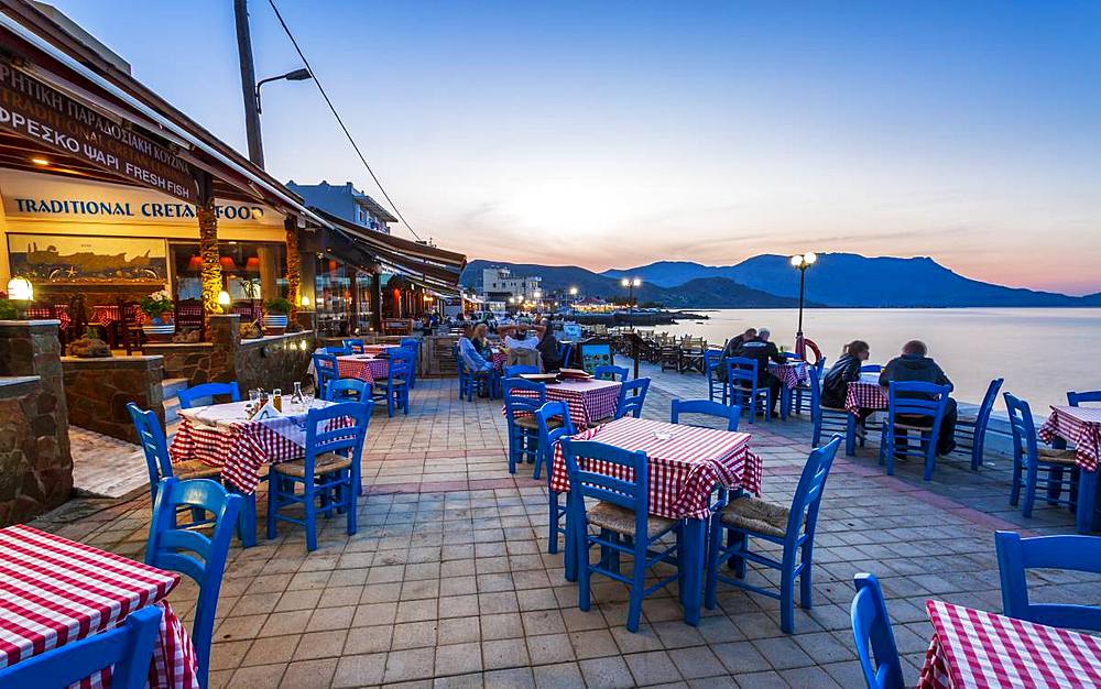 Traditional Cretan Food Restaurant at Paraliaki promenade at sunset in Kissamos, Crete, Greek Islands, Greece, Europe