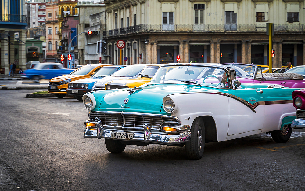 Colourful old American taxi cars parked in Havana at dusk, UNESCO World Heritage Site, La Habana, Cuba, West Indies, Caribbean, Central America