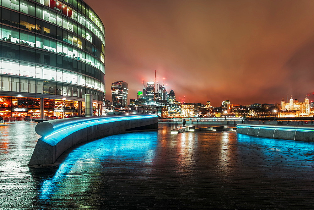 View of London skyline and Tower of London visible in background at night, Southwark, London, England, United Kingdom, Europe