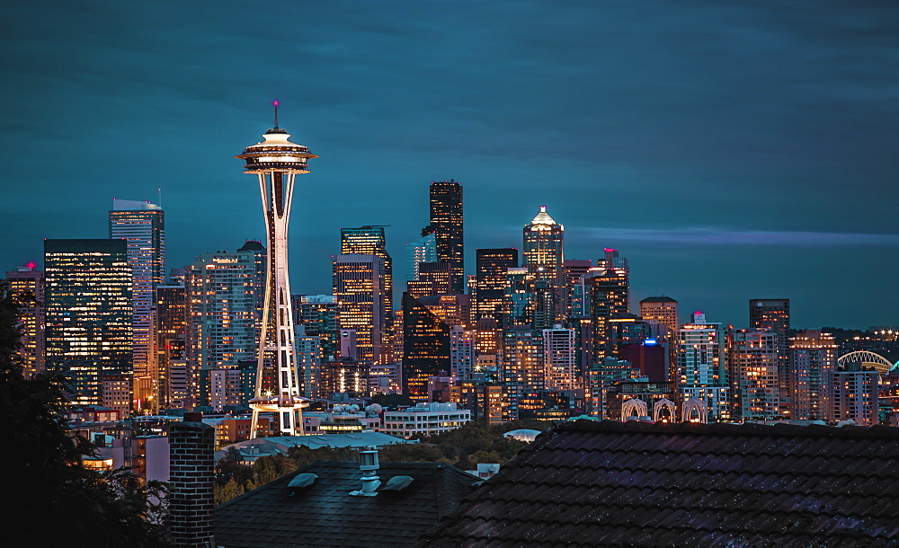 Seattle city skyline at night with urban office buildings and Space Needle viewed from garden near Kerry Park, Seattle, Washington State, United States of America, North America