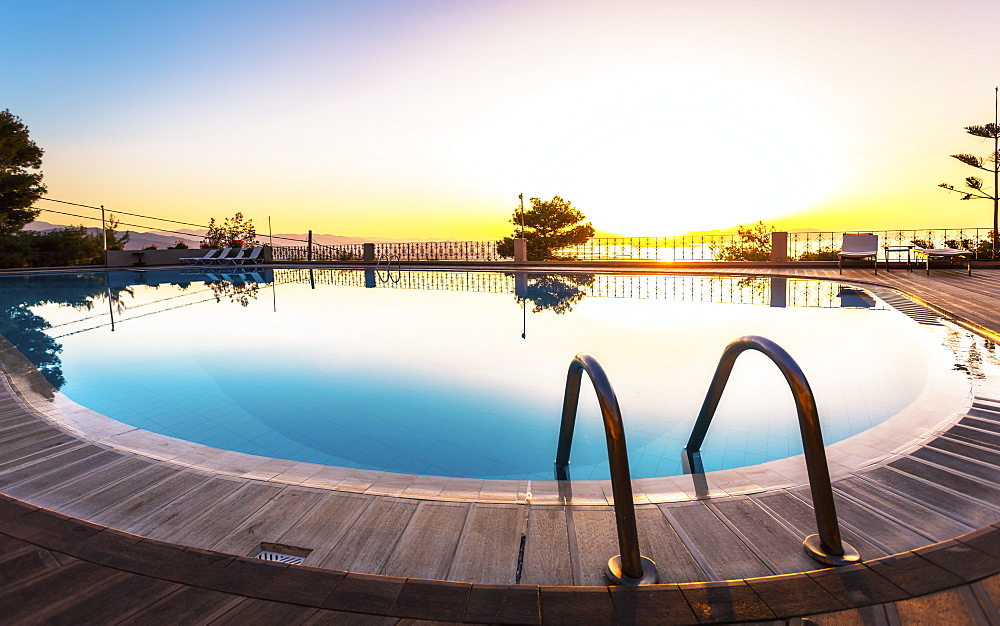 Large swimming pool and sunset over Chania, Crete, Greek Islands, Greece, Europe