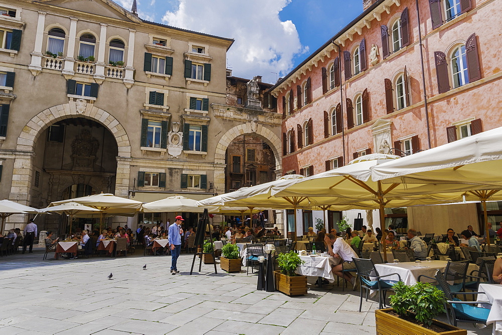 Piazza dei Signori, with crowd eating at restaurants in front of Palazzo Domus Nova on left and Casa della Pieta on right, Verona, Veneto, Italy, Europe