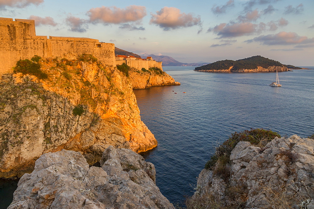 View to Lovrijenac Fortress (St. Lawrence Fortress), the city walls and Lokrum Island at sunset, Croatia, Europe