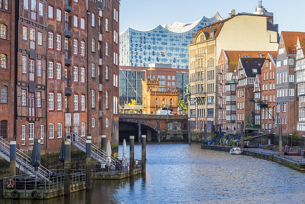 Historical buildings at Nikolaifleet with view to the Elbphilharmonie building in the background at first sunlight, Hamburg, Germany, Europe