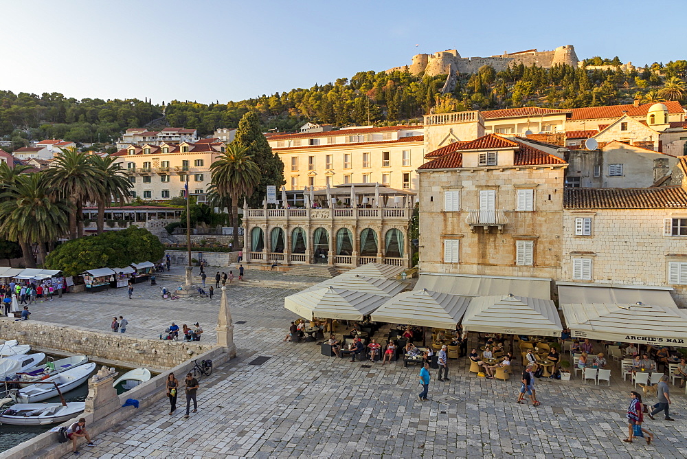 Elevated view over the main square (Trg Svetog Stjepana) and the Spanish Fortress in Hvar Town at first sunlight, Hvar, Croatia, Europe