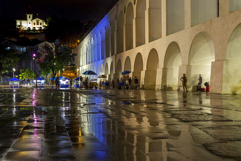 Night shot of the Lapa Arches and the Santa Teresa Convent with reflections on the wet ground shortly after rainfall, Rio de Janeiro, Brazil, South America