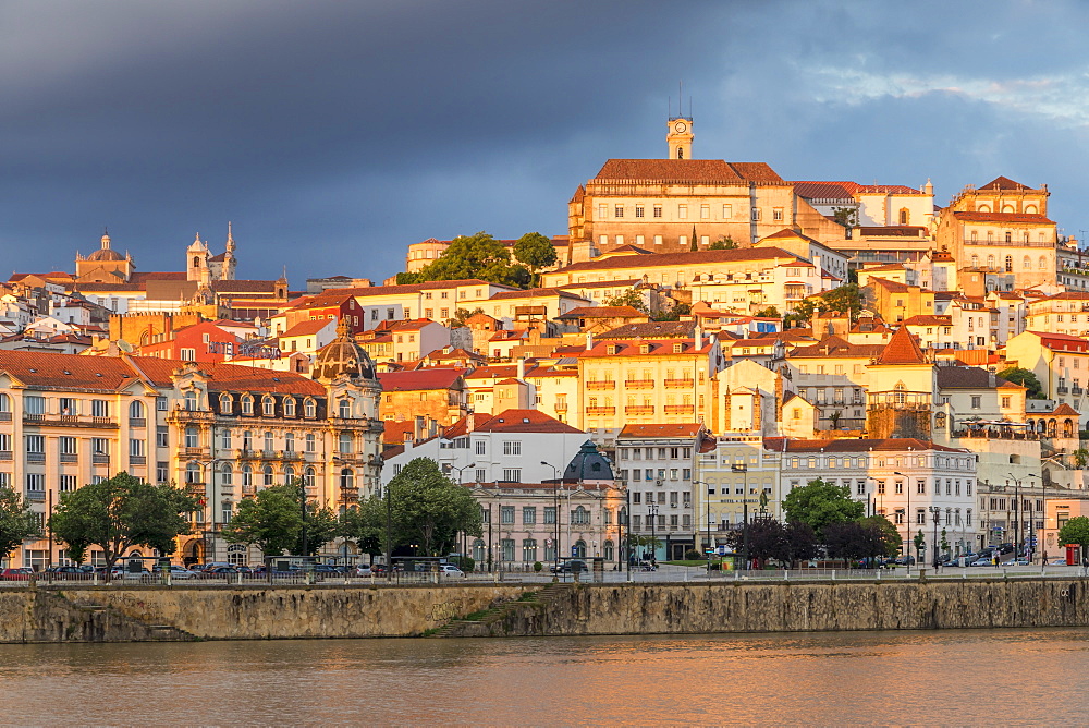 View from Mondego River to the old town with the university on top of the hill at sunset, Coimbra, Portugal, Europe