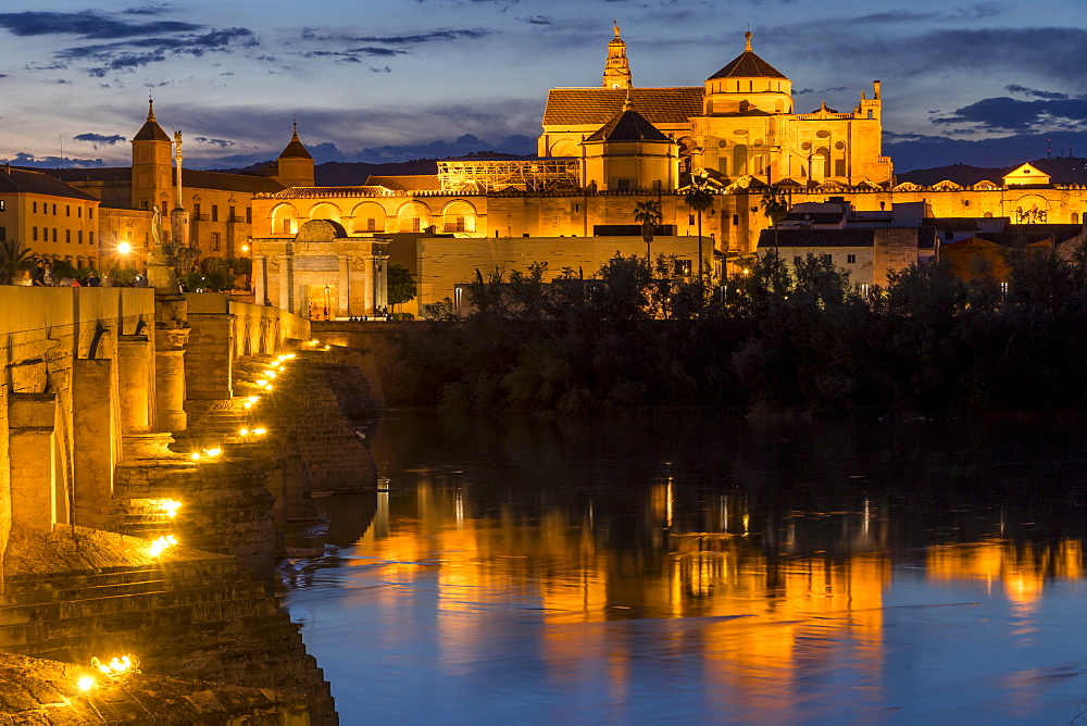 The illuminated Mosque-Cathedral (Great Mosque of Cordoba) (Mezquita) and the Roman Bridge at dusk, UNESCO World Heritage Site, Cordoba, Andalusia, Spain, Europe