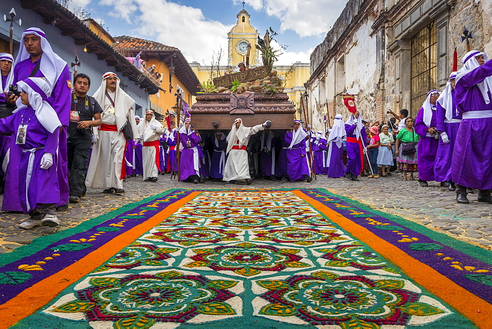 Good Friday Procession approaching a sawdust carpet during Holy Week 2017 in Antigua, Guatemala, Central America