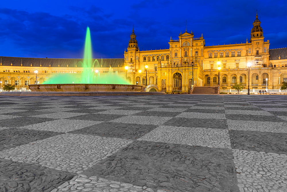 Illuminated fountain and main buildiung at Plaza de Espana at dusk, Seville, Andalusia, Spain, Europe