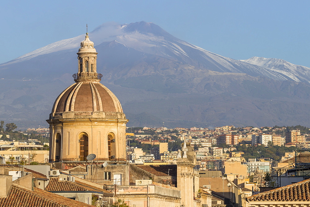 The cupola of Saint Michael church and Mount Etna in the background, Catania, Sicily, Italy, Europe