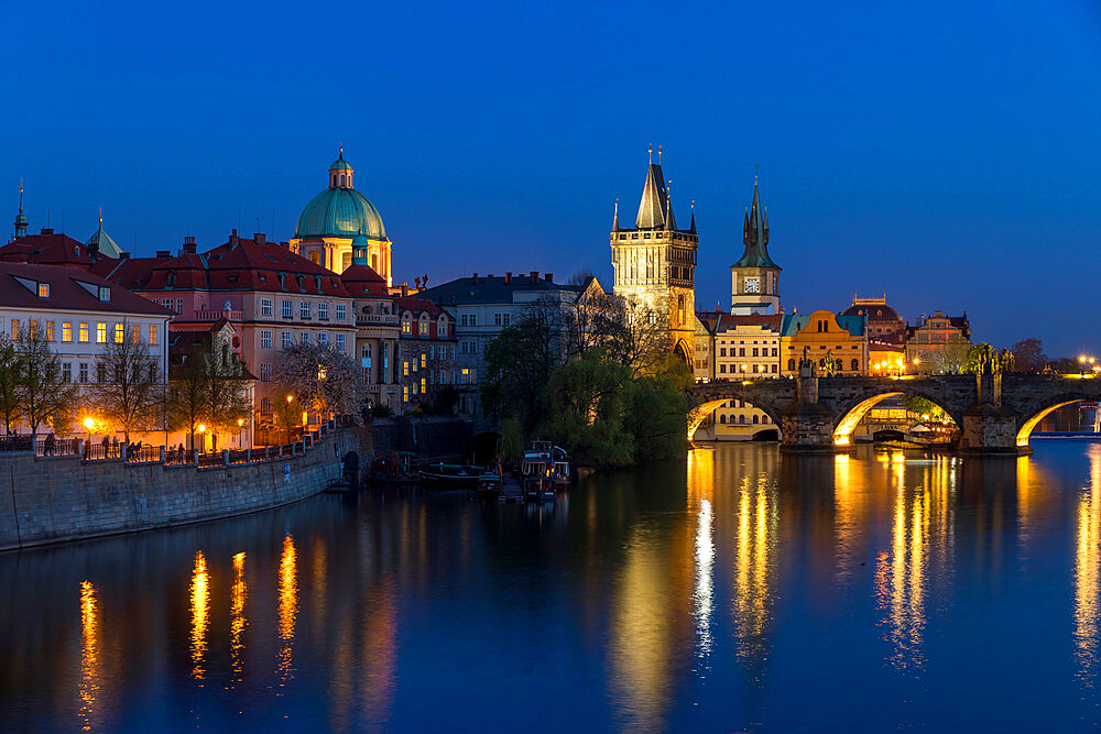 View over Charles Bridge, Old Town Bridge Tower and Vltava River at dusk, UNESCO World Heritage Site, Prague, Bohemia, Czech Republic, Europe