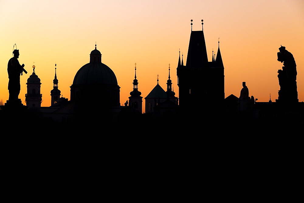 Silhouette of the old town buildings seen from Charles Bridge at sunrise, UNESCO World Heritage Site, Prague, Bohemia, Czech Republic, Europe