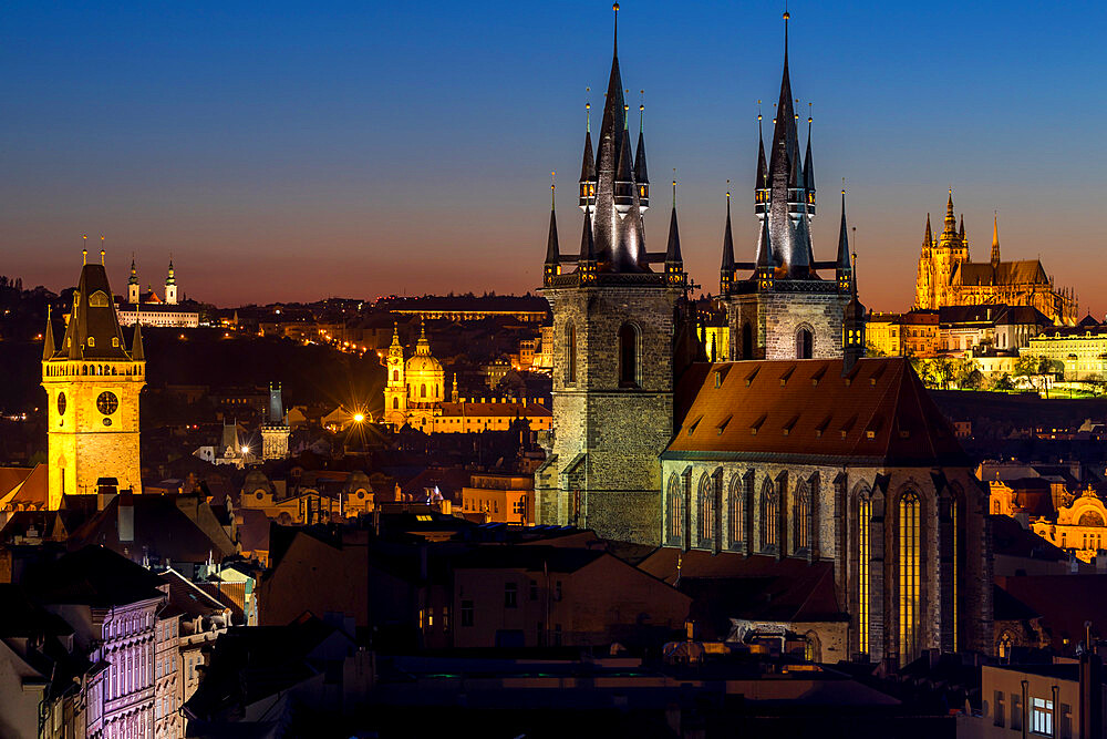 View to Our Lady before Tyn Church, the Old Town Hall Clock Tower and Prague Castle at dusk, UNESCO World Heritage Site, Prague, Bohemia, Czech Republic, Europe