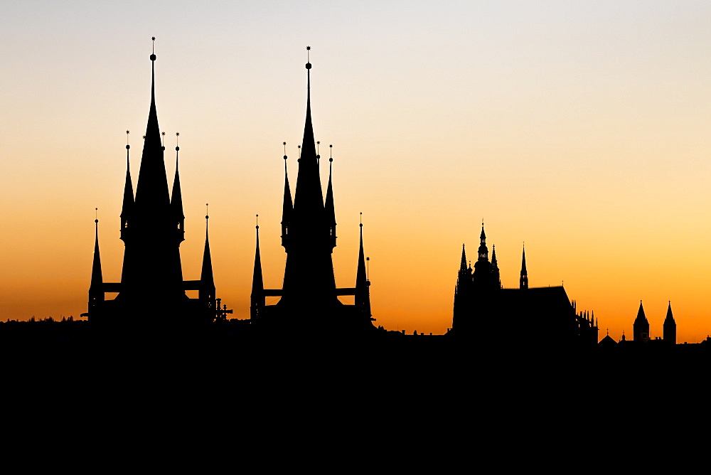 Silhouettes of Our Lady before Tyn Church and St. Vitus Cathedral at sunset, UNESCO World Heritage Site,Prague, Bohemia, Czech Republic, Europe