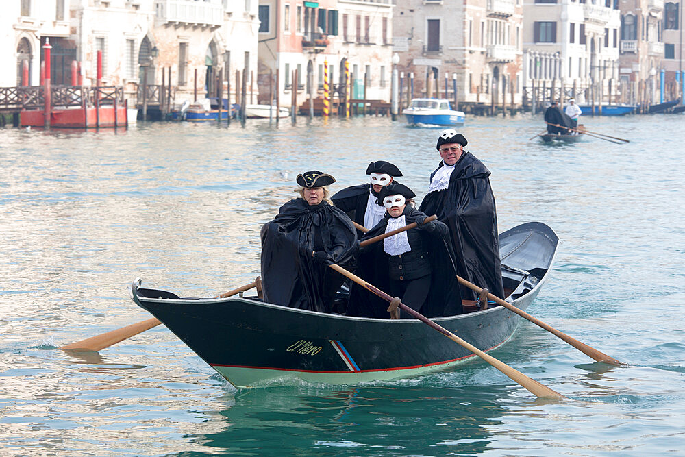 People in Venice Carnival costumes, rowing gondola on Grand Canal, Venice, UNESCO World Heritage Site, Veneto, Italy, Europe