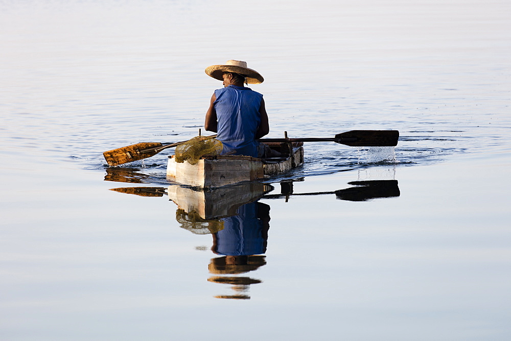 Fisherman on small rowing boat made of polystyrene blocks, Cienfuegos, UNESCO World Heritage Site, Cuba, West Indies, Caribbean, Central America