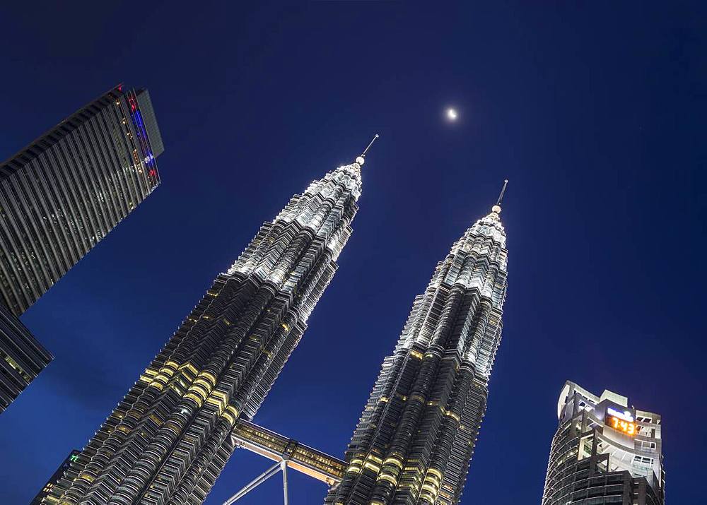 Petronas Twin Towers with the moon showing in between, Kuala Lumpur, Malaysia, Southeast Asia, Asia