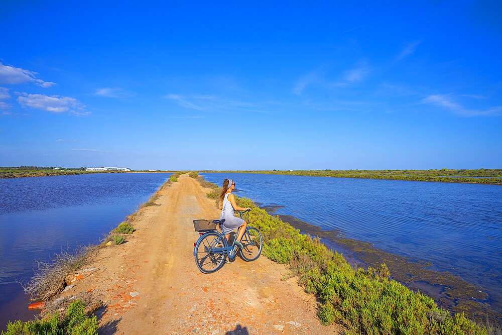 Cycling in the Forte do Rato salt flats, Tavira, Algarve, Portugal