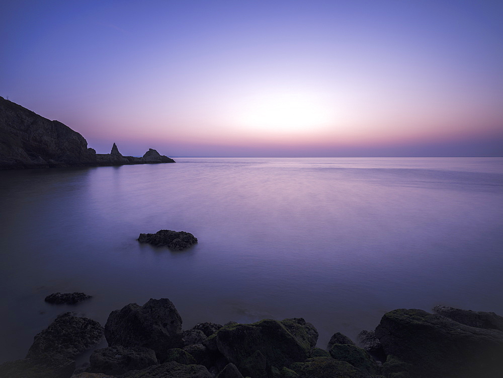 Cool dawn twilight looking out into Torbay, Anstey's Cove, Torquay, Devon, England, United Kingdom, Europe