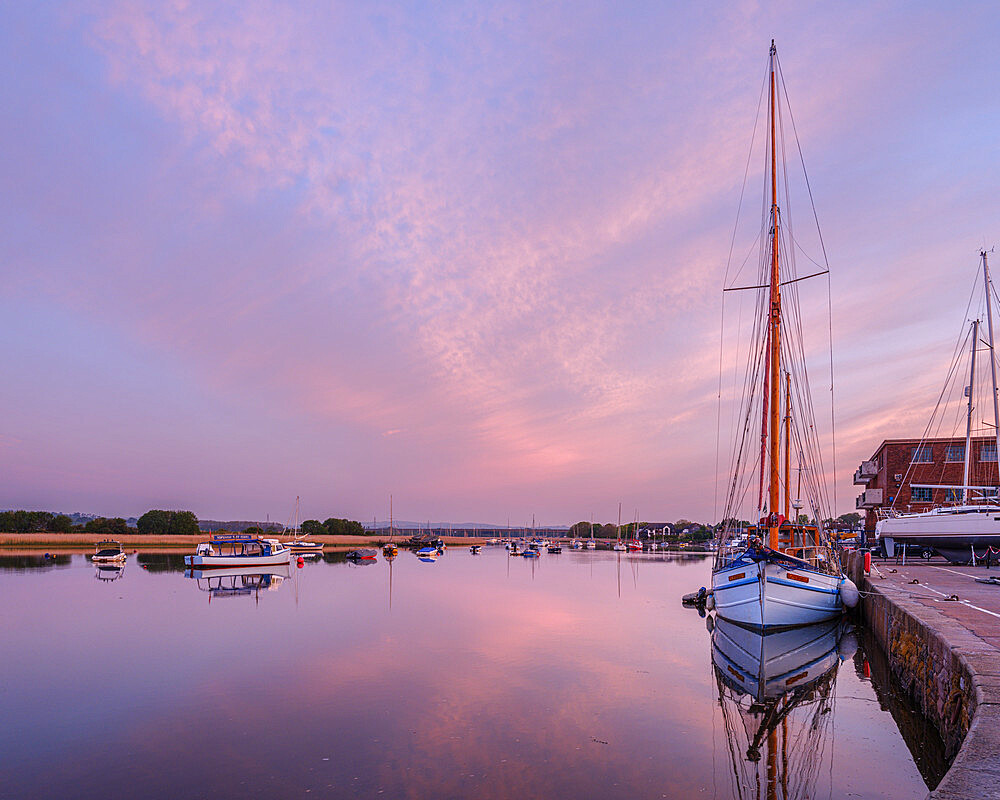 Turf Ferry and other boats moored on a mirror calm River Exe at Topsham, Devon, England, United Kingdom, Europe