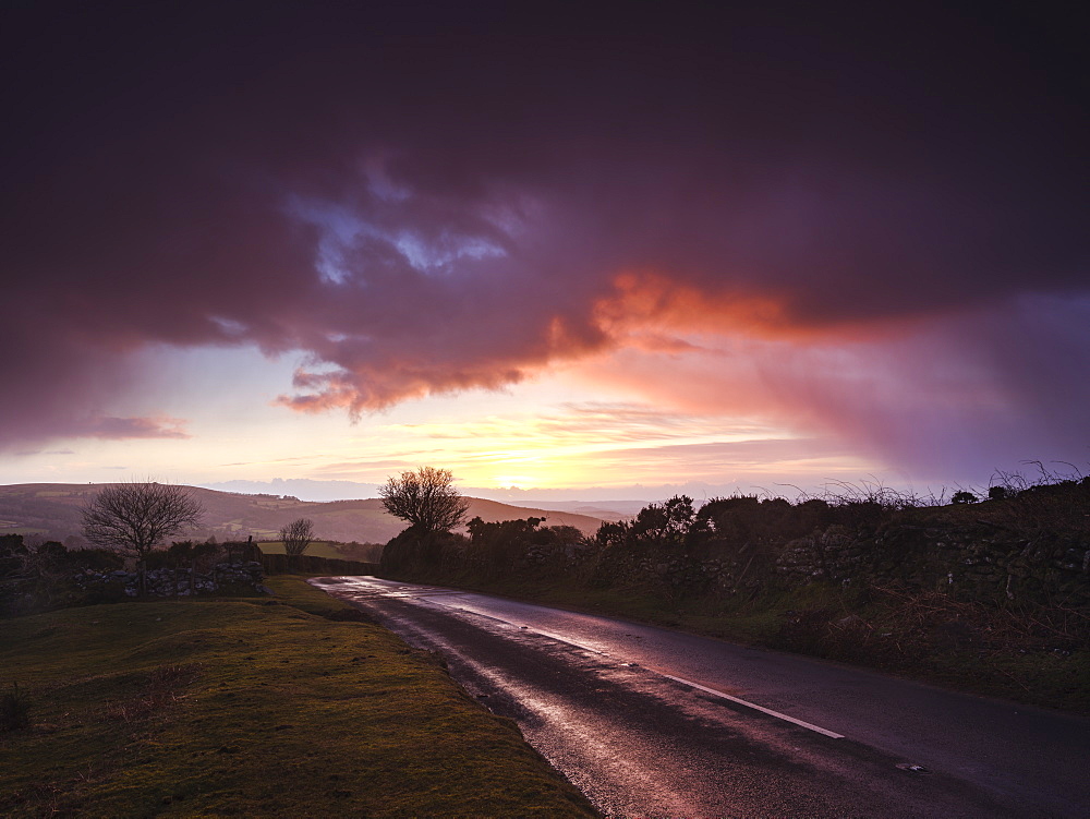 Moody winter sunrise in a hail shower at Bel Tor Corner, Dartmoor National Park, Ashburton, Devon, England, United Kingdom, Europe