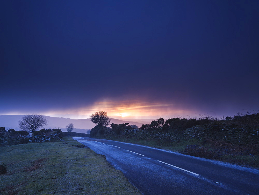 Moody winter sunrise in a hail shower at Bel Tor Corner, Dartmoor National Park, Ashburton, Devon, England, United Kingdom, Europe