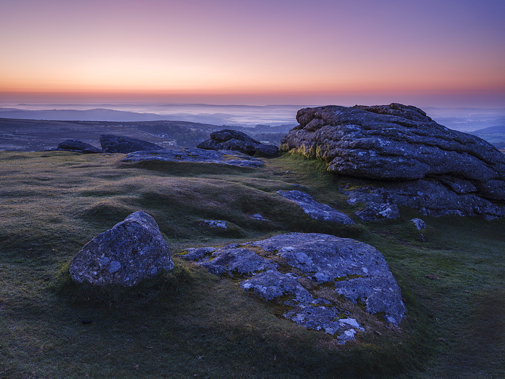 Views over Dartmoor National Park and mist in the Teign Valley seen from summit of Haytor, Bovey Tracey, Devon, England, United Kingdom, Europe