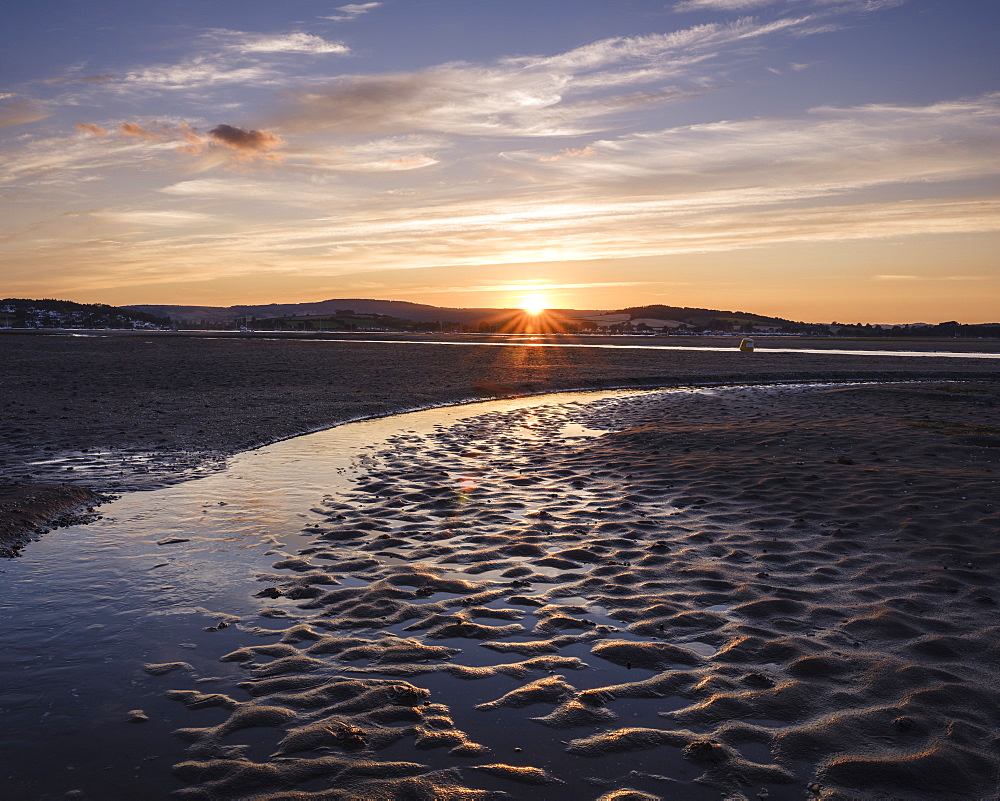 Looking at the setting sun across the Exe estuary towards Starcross from Exmouth, Devon, England, United Kingdom, Europe