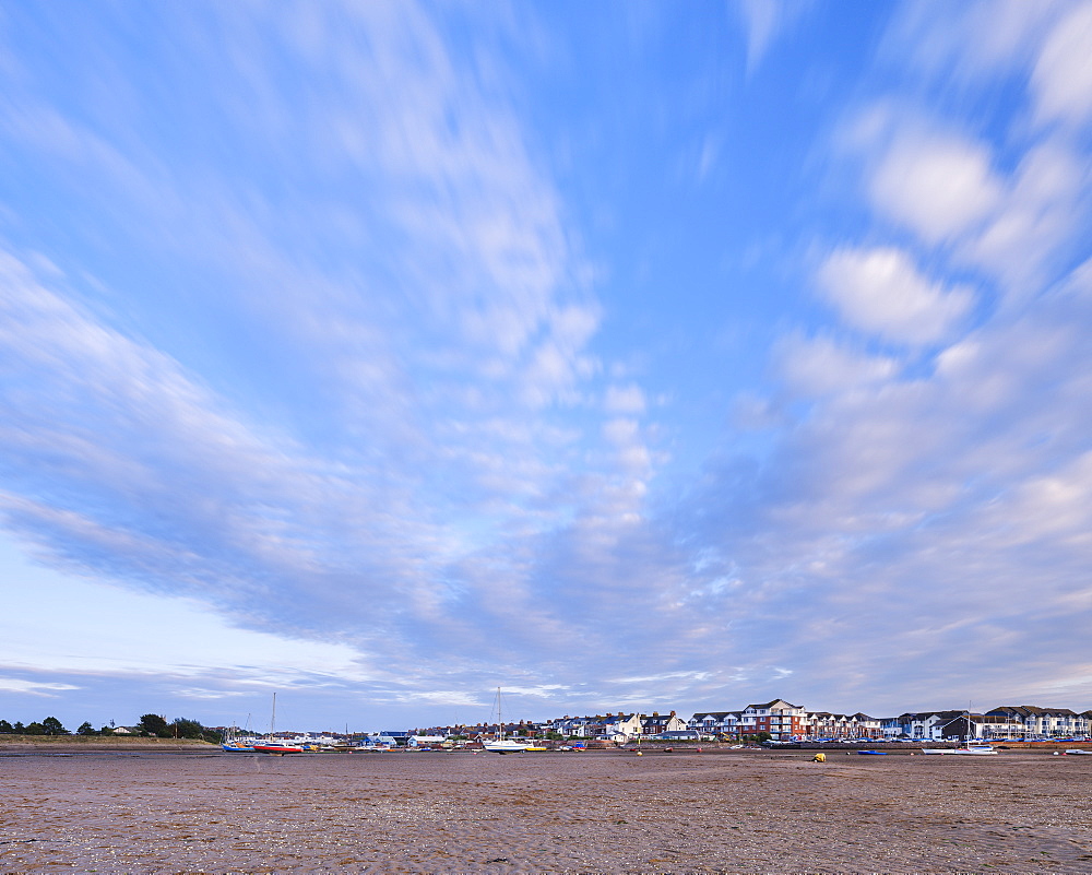 Sun illuminates houses and boats at Shelley Beach, Exmouth, Devon, England, United Kingdom, Europe