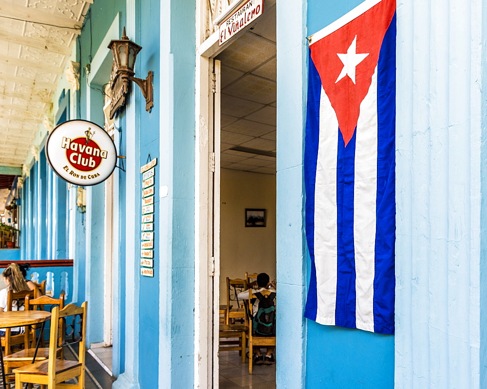 A Cuban flag outside a restaurant in Vinales town, Vinales, Pinar del Rio, Cuba, West Indies, Caribbean, Central America