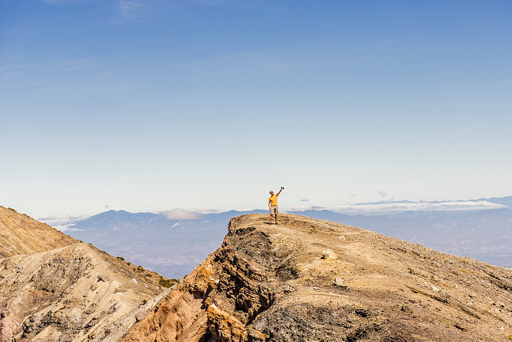 A tourist taking a selfie on top of the Santa Ana Volcano (Ilamatepec) in Santa Ana, El Salvador, Central America