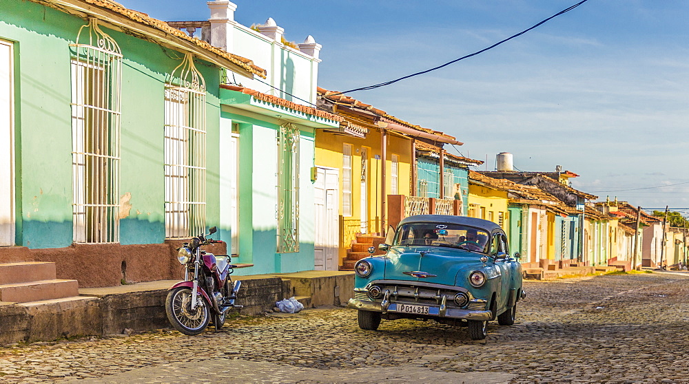 A classic car in a colourful colonial street in Trinidad, UNESCO World Heritage Site, Cuba, West Indies, Caribbean, Central America