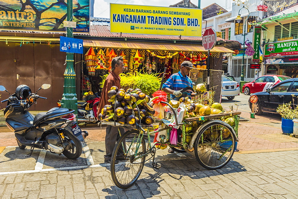 A mobile coconut seller and his stall in Little India, George Town, Penang Island, Malaysia, Southeast Asia, Asia